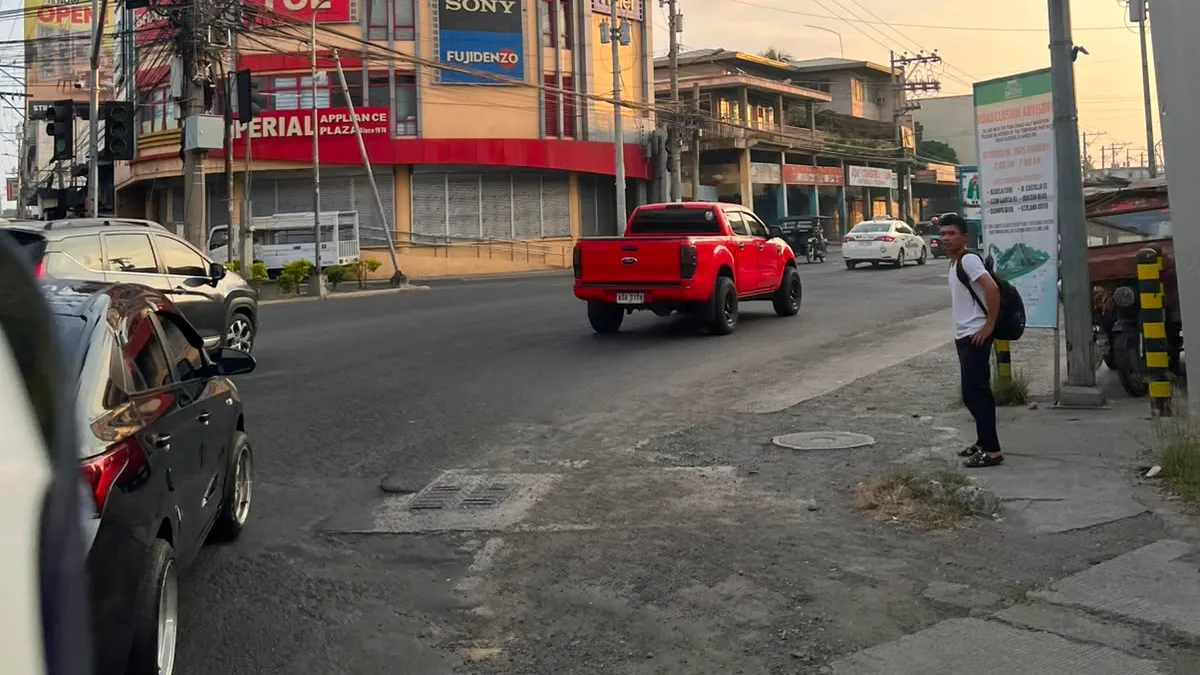 Appliance plaza on a signalised corner with a pickup crossing the junction