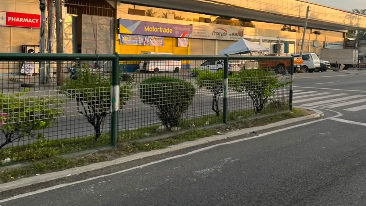 Pharmacy and motorcycle dealership tucked beneath an elevated flyover