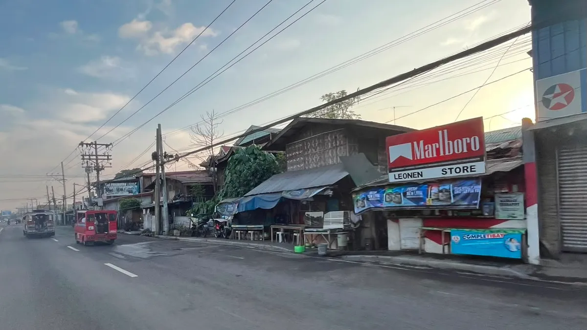 Roadside sari-sari store with painted signage at dawn