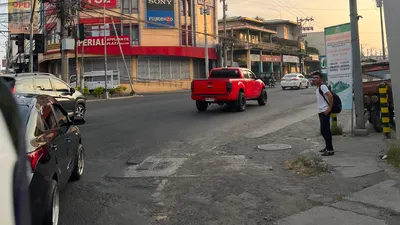 Appliance plaza on a signalised corner with a pickup crossing the junction