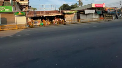 Two-storey shophouses with rented rooms above along a Davao barangay road