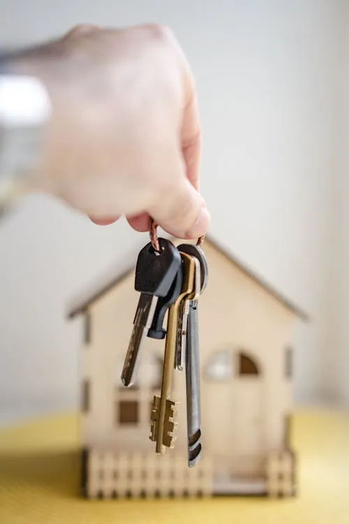 Person holding apartment keys after securing a rental