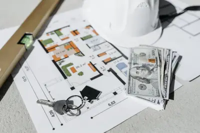 House keys on a floor plan with Philippine peso bills